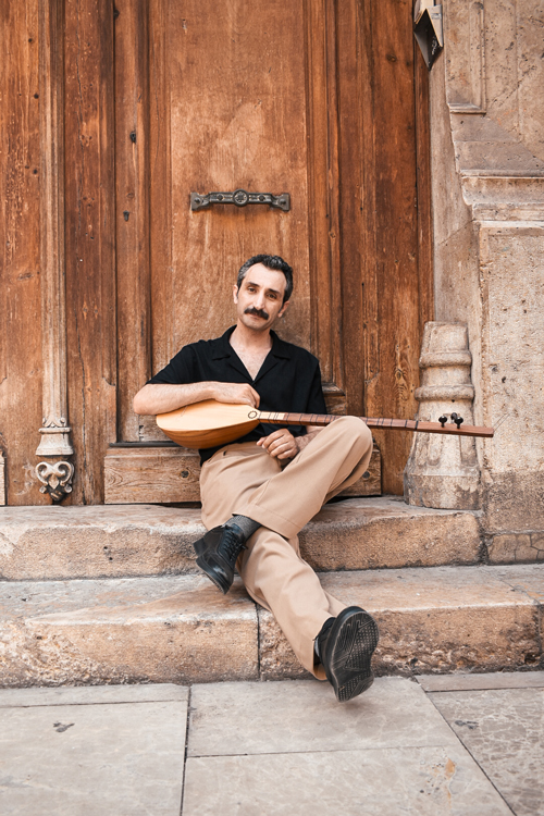 Ali Doğan Gönültaş sitting on door steps