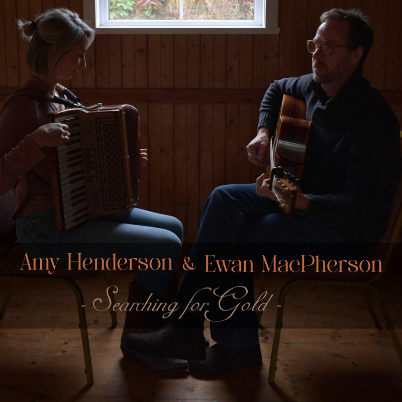 Amy Henderson & Ewan MacPherson Searching for Gold cover artwork. A photo of the two artists inside a room, playing their musical instruments, facing each other.