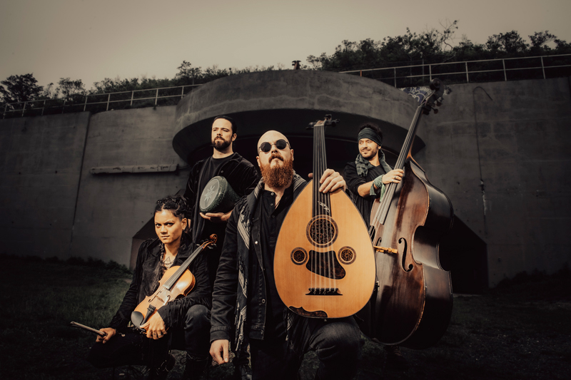 Baklava Express by Aiden Grant. Color photo, outdoors, with band members holding their musical instruments.