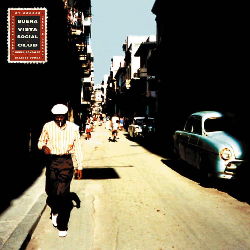 Buena Vista Social Club album cover. A street in Havana, showing a man walking towards the camera next to a blue vintage car.