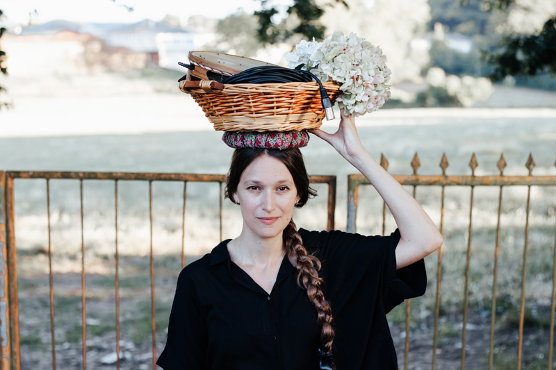 Carmela - photo by Eva Pombo. Carmela carrying a basket on her head.