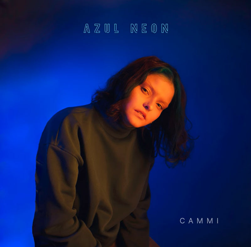 Cammi Azul Neon single artwork. A photo of the artist with a neon blue background.