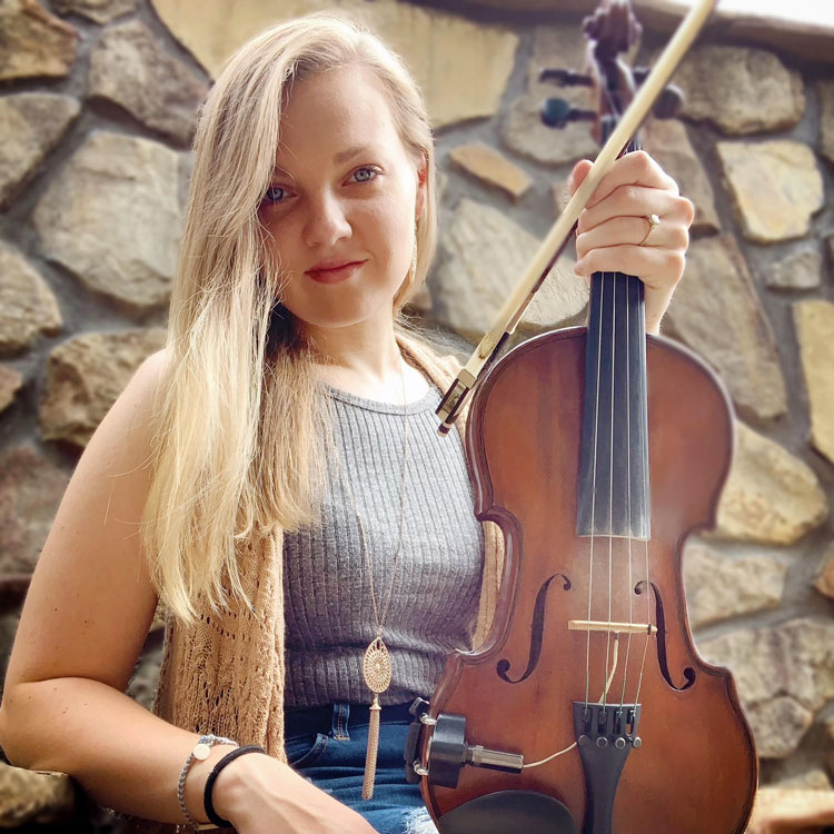 bluegrass artist Carley Arrowood holding her fiddle