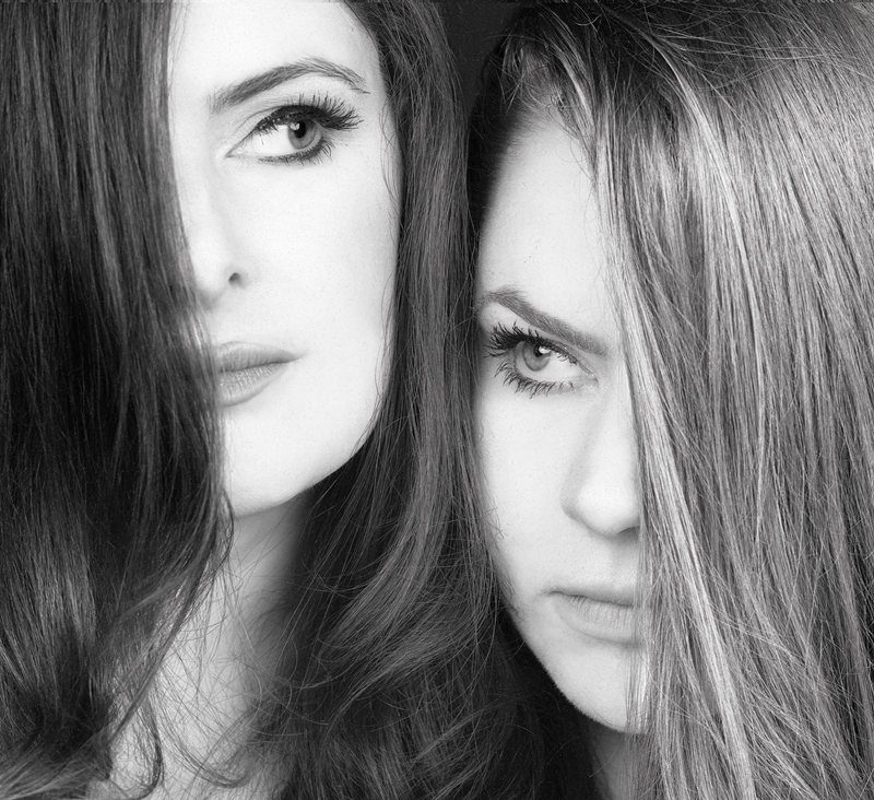 Cassie and Maggie - Gold And Coal cover artwork. A photo of the heads of the sisters covering their face partially with their long hair.