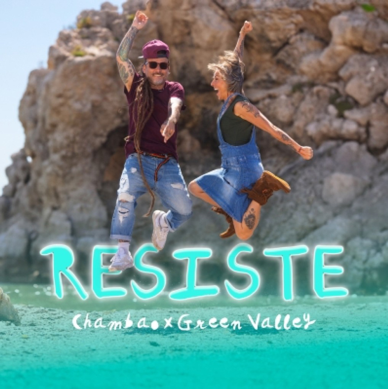 The single cover for Resiste by Chambao x Green Valley shows two people mid-jump on a rocky beach, radiating joy and energy. The title RESISTE appears in large glowing turquoise letters, while the artists’ names are written in a white script beneath it.