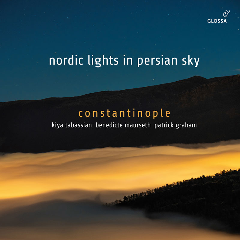 The album cover for Nordic Lights in Persian Sky features a mountainous landscape at dusk. A layer of glowing mist—lit in warm gold—blankets the valley below, contrasting with the dark ridge and deep blue sky above. The album title in lowercase white, while the artist names—Constantinople, Kiya Tabassian, Benedicte Maurseth, and Patrick Graham—appear below in smaller, elegant fonts. The Glossa logo is placed subtly in the top-right corner.