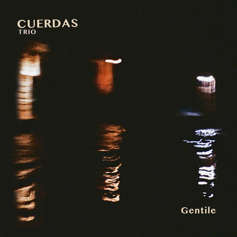 A dark, nearly black background holds a few blurred streaks of orange and white light that ripple like reflections on water. The group name “Cuerdas Trio” appears in a light serif font at the upper left, while the album title Gentile rests in the lower right in the same tone.