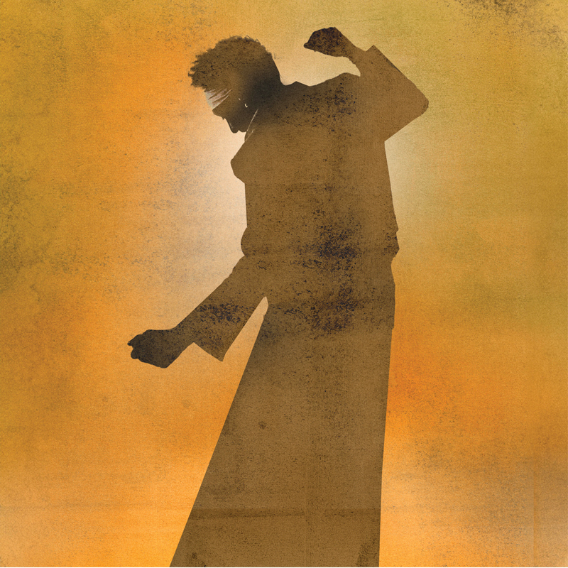 A silhouetted figure dances against a grainy gradient of yellows and oranges. The person wears a long coat and appears blindfolded, with light creating a soft halo behind the head.