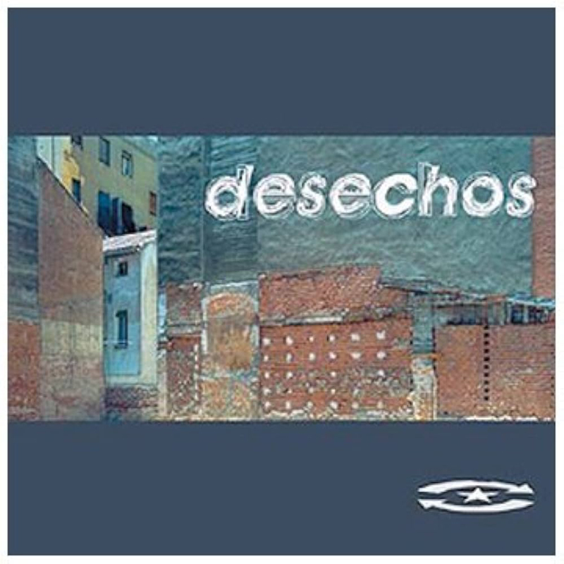 The album cover for Cuando Es Mañana by Desechos features a blurry photograph of an urban wall composed of exposed bricks and faded plaster. The band’s name appears in a chalk-like white font across the upper center, with a dark blue border framing the image and a small circular logo with a star at the bottom right.