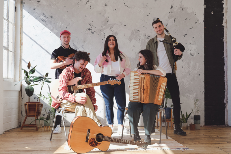 Eabhal - Photo by by Nicky Murray. Band photo indoors, holding their musical instruments.