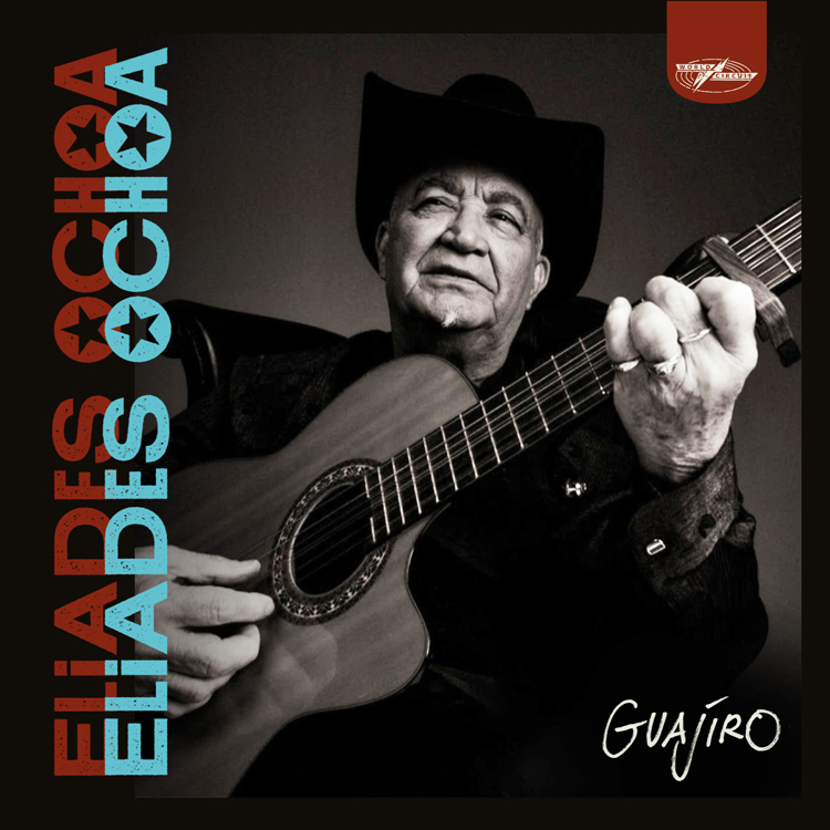 Eliades Ochoa - Guajiro cover artwork. A photo of Eliades playing guitar, wearing his signature black hat.
