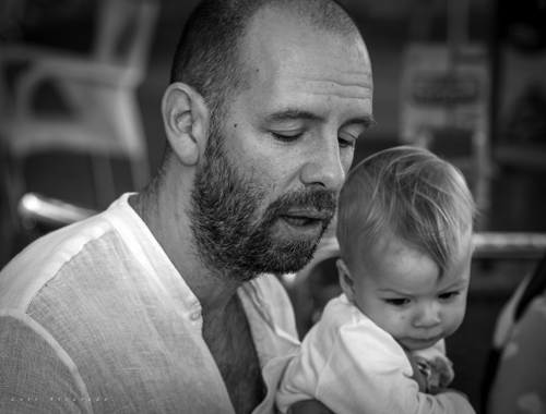 Vincent holds his child - Photo by Luis Alvarado