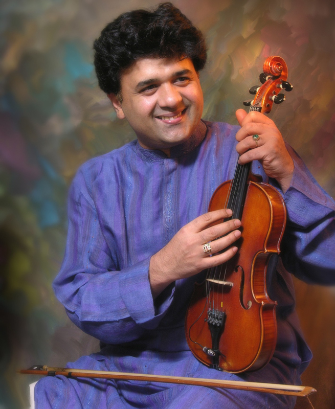 Ganesh Rajagopalan holding a violin