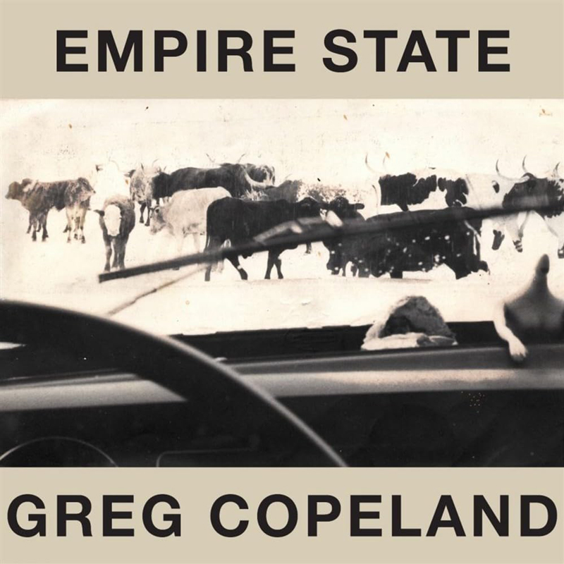 The album cover for Empire State by Greg Copeland features a sepia-toned image viewed from inside a car. Through the windshield, a herd of cattle stands in the snow, partially obscured by a windshield wiper mid-swipe. The artist's name and album title are boldly displayed in black, all-caps text on beige bands at the top and bottom, respectively.
