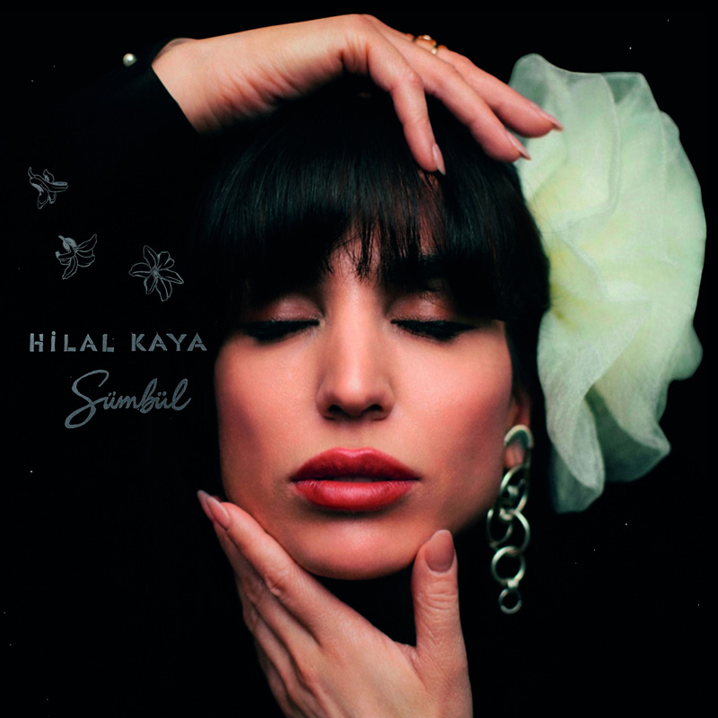 Hilal Kaya - Sümbül cove artwork. A hedshot of Hilal with one hand on her head and the other holding her chin.