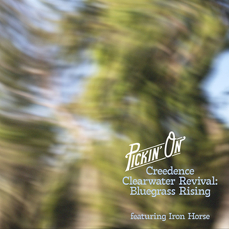 The album cover for Pickin’ On Creedence Clearwater Revival: Bluegrass Rising features a blurred, swirling image of green foliage and sky. The album title is centered in white and light blue text, with “Pickin’ On” in a retro script and “featuring Iron Horse” below in smaller type.