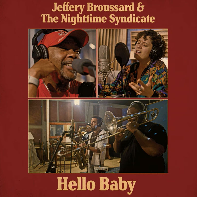 The single cover for Hello Baby by Jeffery Broussard & The Nighttime Syndicate features a vintage-inspired design with a deep red background. It shows three separate photographs of musicians in a recording studio: Jeffery Broussard singing into a microphone with headphones on, a female vocalist performing, and a group of horn players.