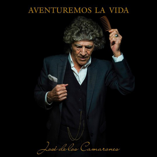 The album cover for Aventuremos La Vida by José de los Camarones features the artist mid-gesture, comb in hand, dressed in a dark three-piece suit with a pocket watch chain. Set against a black background, with golden serif text.
