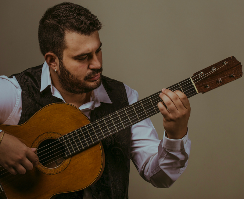 Juan Antonio Moya playing guitar.