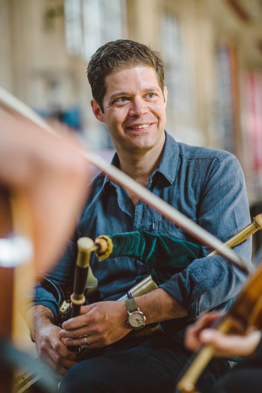 Kieran O’Hare holding a bagpipe - Photo by Earl Richardson