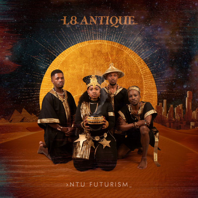 A golden desert scene frames four figures in black-and-gold ceremonial dress, centered before a halo. A smoking vessel centers the composition, while pyramids and a stylized city rise in the background beneath a star-filled sky. The title Ntu Futurism appears below, with L8 Antique above in metallic lettering.