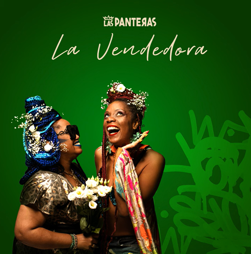 The single cover for Las Panteras – La Vendedora features a green backdrop with graffiti-style accents, two women adorned with flowers and colorful braids. One holds a bouquet and wears oversized sunglasses, while the other beams upward, wrapped in a scarf. The title and artist name appear in white script and bold caps.