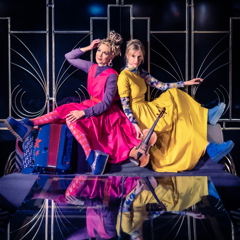 Lena Jonsson & Johanna Juhola wearing colorful dresses