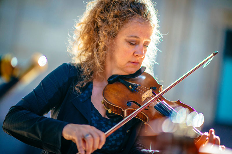 Liz Knowles - Photo by Earl Richardson. The artist playing fiddle.