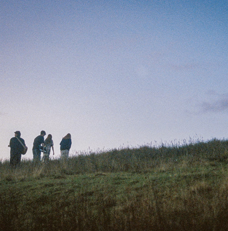 Lussa Lussa Reels cover artwork. A distant photo of the band members in the countryside.