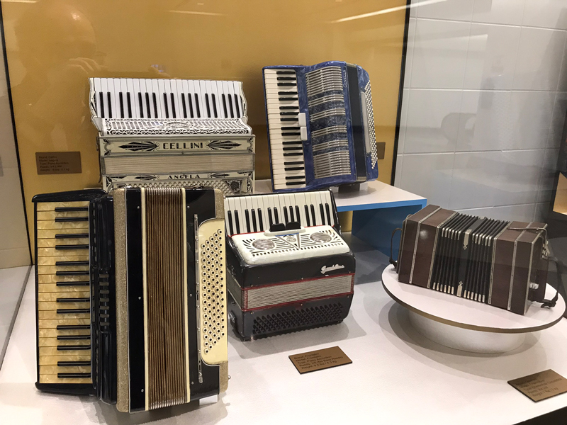 Making The Accordion Great Again: Liberty Bellowsexhibiiton - Photo by Angel Romero. Various accordions on display.