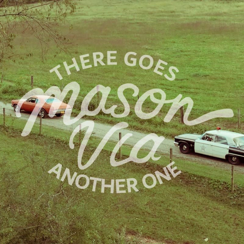 Mason Via There Goes Another One single artwork. A 1960s-1970s police car chasing a red sports car through a rural road.