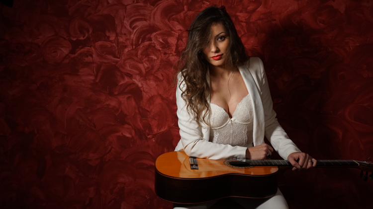 flamenco guitarist Mercedes Luján holding a guitar