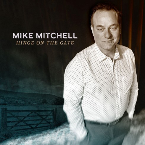 Mike Mitchell- Hinge on the Gate cover artwork. A photo of Mike Mitchell with hands in his pockets.