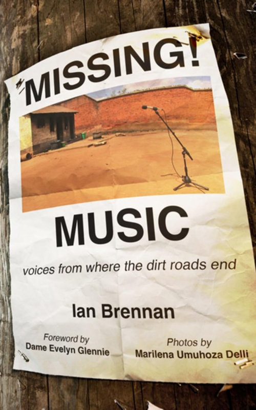 The cover of the book "Missing! Music" features a distressed, worn-out flyer pinned to a wooden surface. The flyer displays an image of a rural, red-earth setting with a single microphone stand in the foreground. The title, "Missing! Music," is prominently displayed in bold black letters, followed by the subtitle, "Voices from Where the Dirt Roads End." The authors' credits include Ian Brennan, a foreword by Dame Evelyn Glennie, and photographs by Marilena Umuhoza Delli.