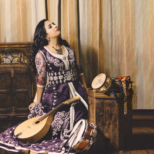 Nabyla Maân sitting next to musical instruments.