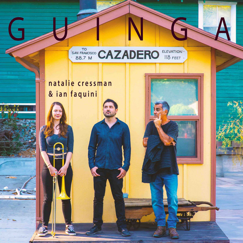 Natalie Cressman and Ian Faquini - Guinga cover artwork. A photo of the three artists standing by a small yellow hut.