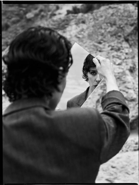 Nita black and white photo. Looking at herself through a mirror.