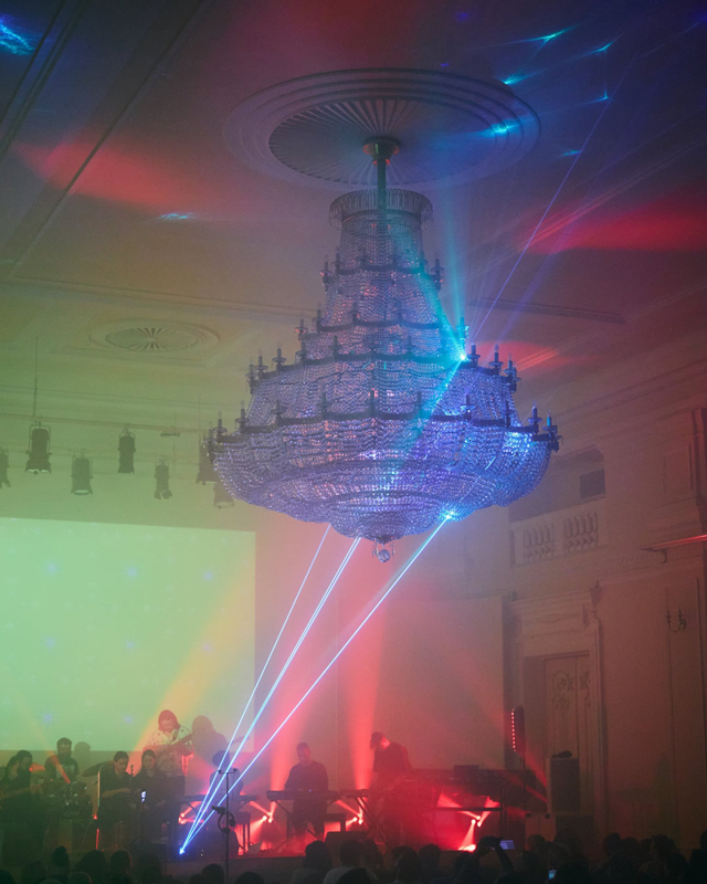 Notations Lab 2026, a laser light show indoors with a large chandelier.