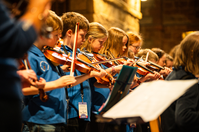 Orkney Traditional Music Project. A photo of children playing fiddle.