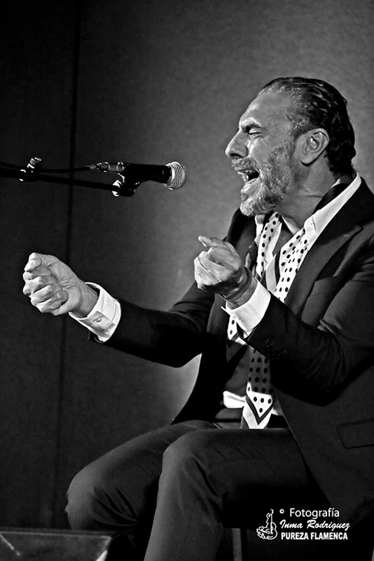 Pedro el Granaíno - Photo by Inma Rodríguez. Blacl and white photo. Pedro singing passionately sitting on a chair.