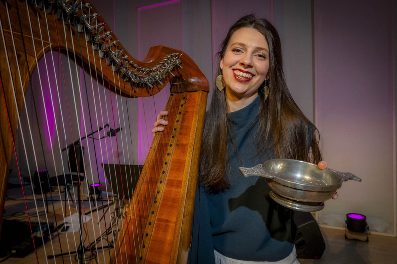 Rachel Groves - Photo by Alan Peebles. Rachel holding her harp and showing the award.