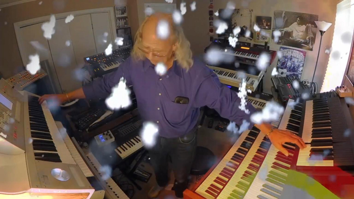 Robeone Winter Dreams. a photo of Robeone surrounded by keyboards.