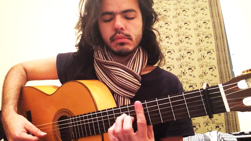 Roberto Monteiro Bastos playing guitar, from one of his music videos.