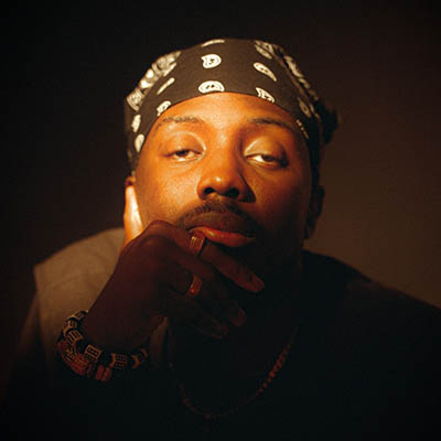 Sam Opoku headshot with a bandana.