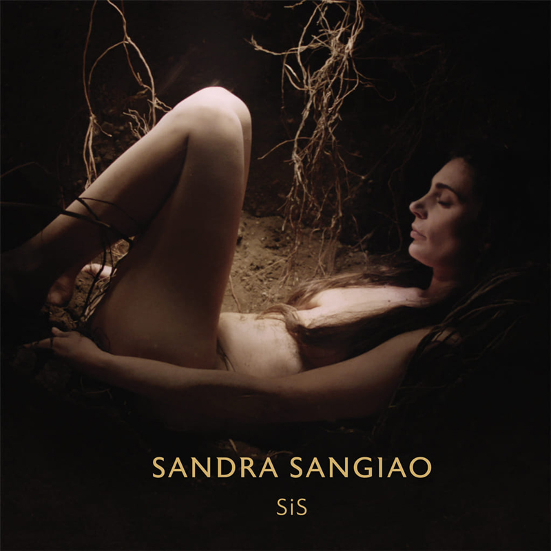 Sandra Sangiao - SiS artwork. The artist lying naked on her back surrounded by roots.