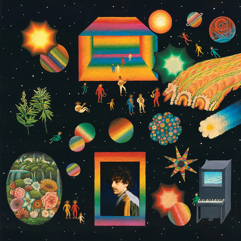 A star-filled black backdrop surrounds a collage of radiant shapes, miniature figures, planets, and dreamlike landscapes. A rainbow-framed portrait of the artist sits near the center, amid swirling cosmic motifs, a lone piano, and vibrant bursts of color.