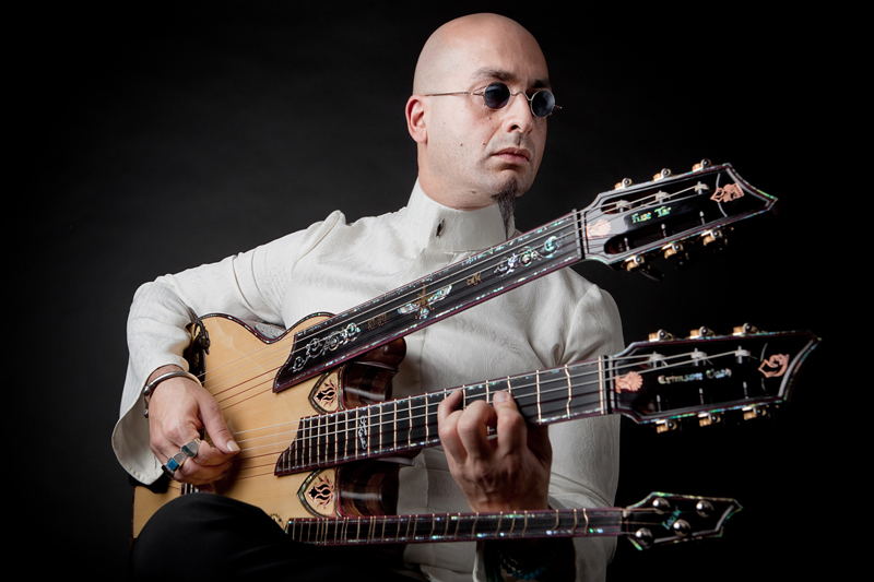 Shahab Tolouie playing his triple neck guitar.