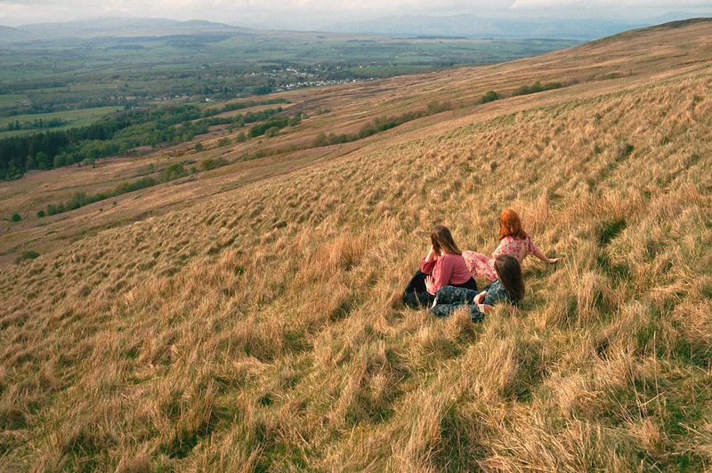 Sian sitting on a field