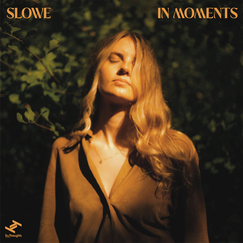 Slowe - In Moments cover artwork. Slowe standing with her eyes closed.