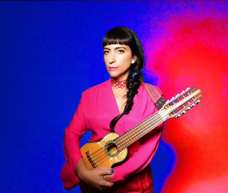 Sofía Rei - Photo by Shrevin Lainez. The artist holding a small guitar.